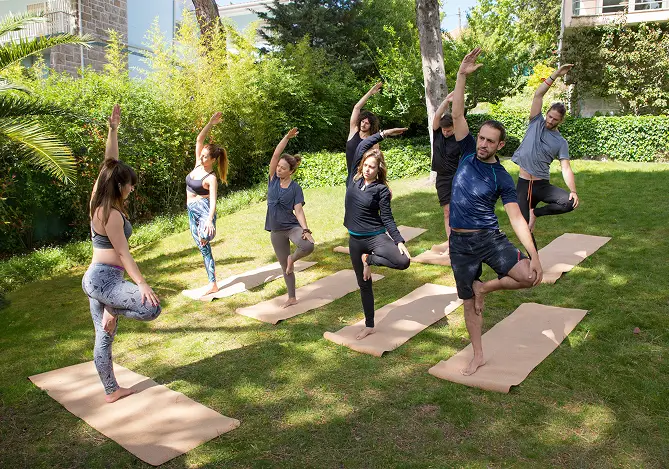 Outdoor group practicing yoga on mats