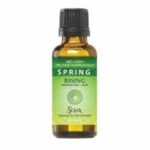 A small amber bottle labeled 'Spring' with essential oil inside.